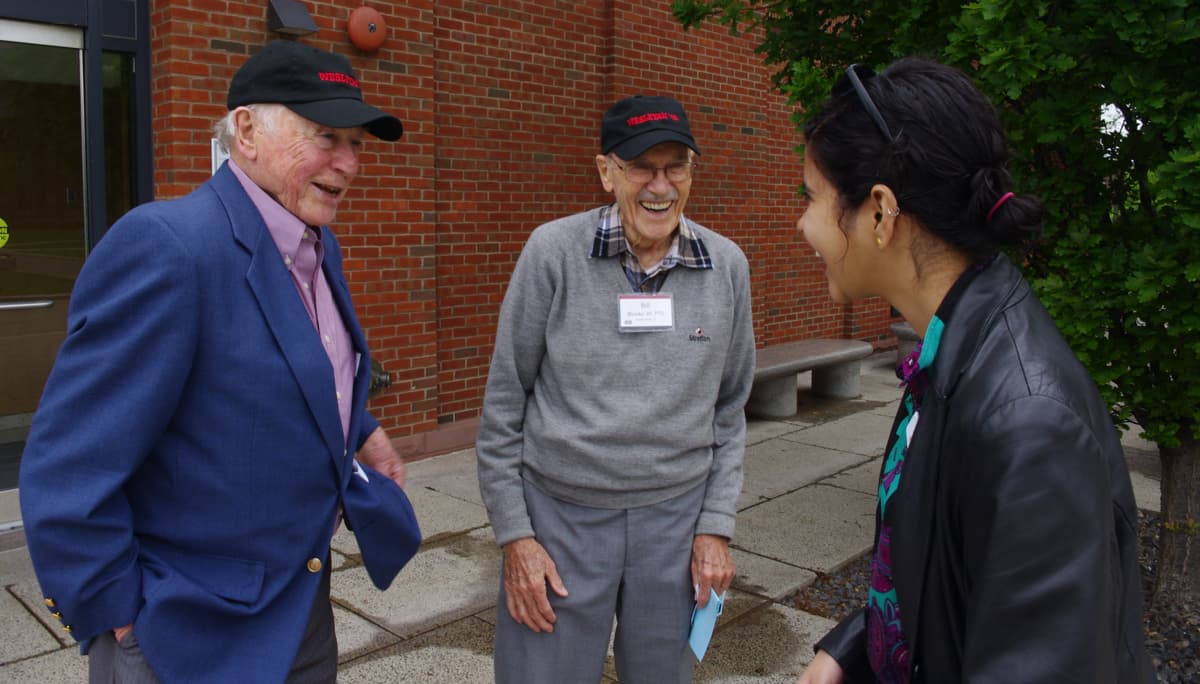 Alumni from the Wesleyan Class of ’49 speak with Aditi outside the Usdan Center.